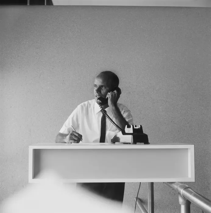 Framed Print : Businessman talking on phone, holding pen Framed Print : Businessman talking on phone, holding pen