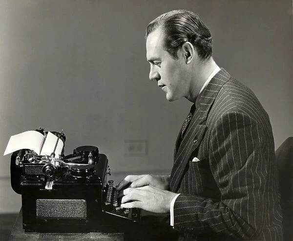 Businessman uses vintage typewriter