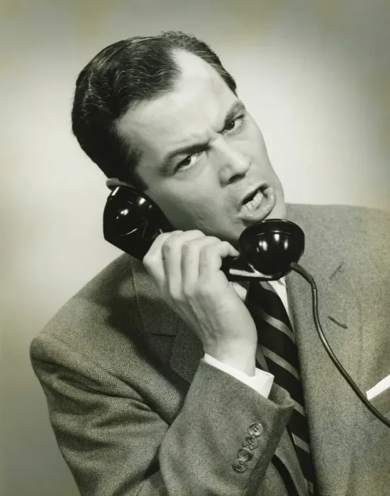 Framed Print : Businessman using phone in studio, (B&W), close-up