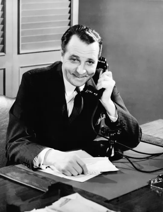 Framed Print : Businessman using telephone at his desk Framed Print : Businessman using telephone at his desk