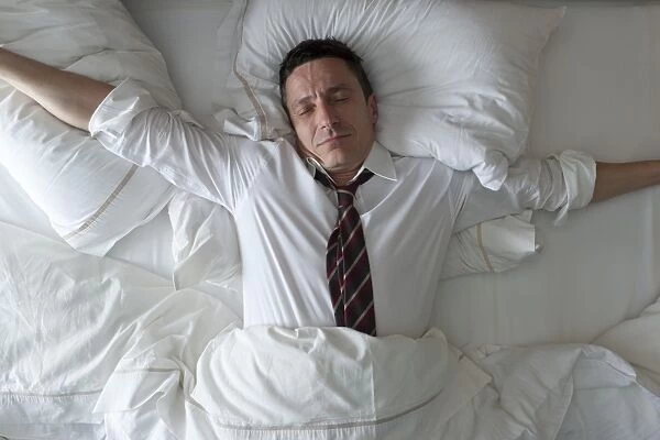 Businessman waking up with clothes on