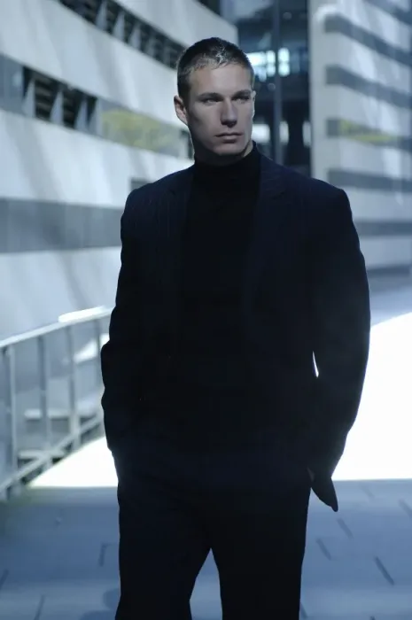 Framed Print : Businessman wearing a dark suit, standing in front of a modern bank building Framed Print : Businessman wearing a dark suit, standing in front of a modern bank building