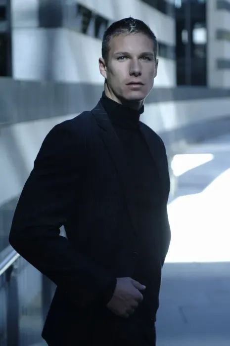 Framed Print : Businessman wearing a dark suit, standing in front of a modern bank building Framed Print : Businessman wearing a dark suit, standing in front of a modern bank building