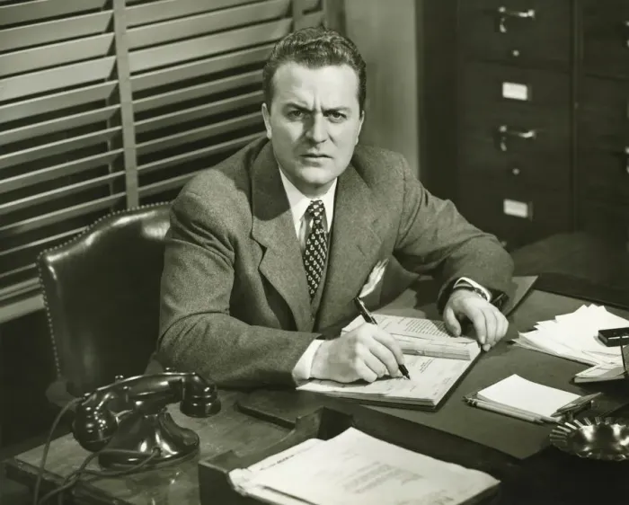 Framed Print : Businessman writing in notepad, sitting at office, (B&W) Framed Print : Businessman writing in notepad, sitting at office, (B&W)