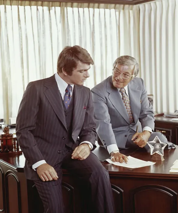 Framed Print : Two businessmen at desk looking at document