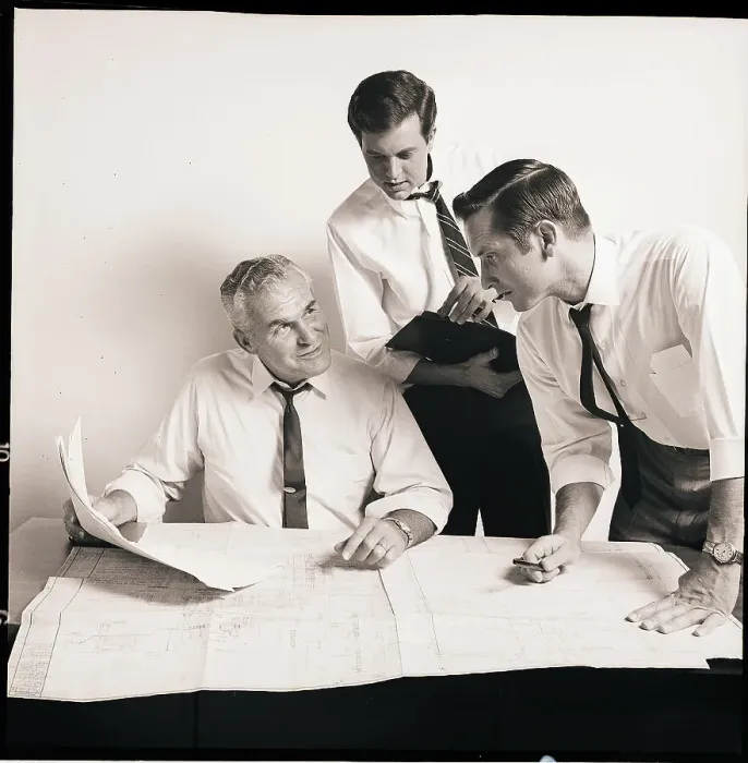 Framed Print : Businessmen Examine A Blueprint Framed Print : Businessmen Examine A Blueprint