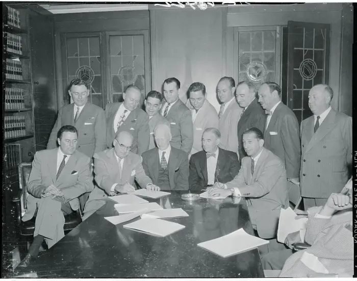 Framed Print : Businessmen Signing an Agreement Framed Print : Businessmen Signing an Agreement
