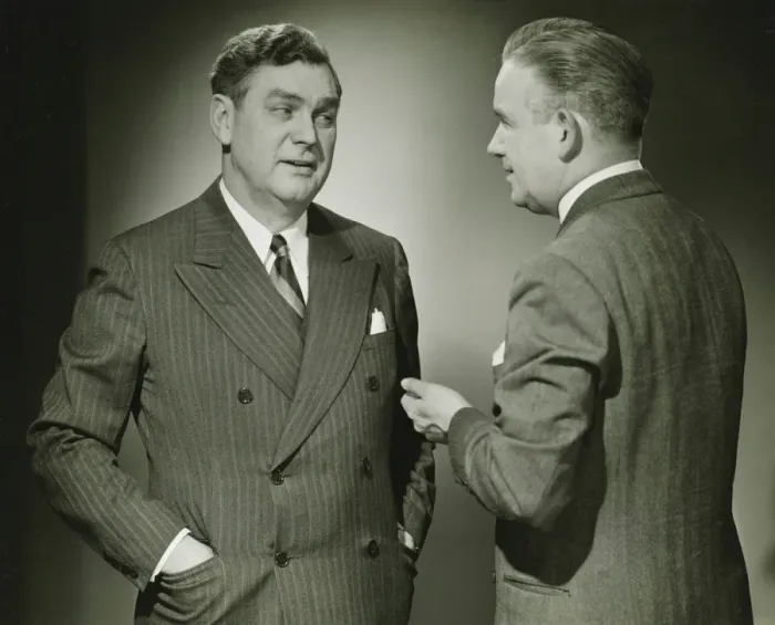 Framed Print : Two businessmen talking in studio, (B&W), portrait Framed Print : Two businessmen talking in studio, (B&W), portrait
