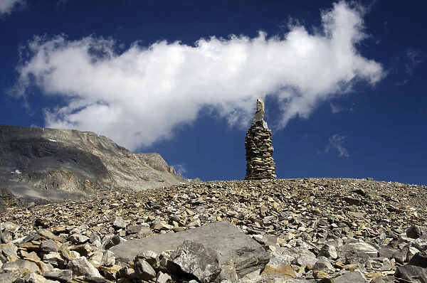 Cairn as signpost and orientation help in rocky alpine terrain without trails, Valais, Switzerland, Europe