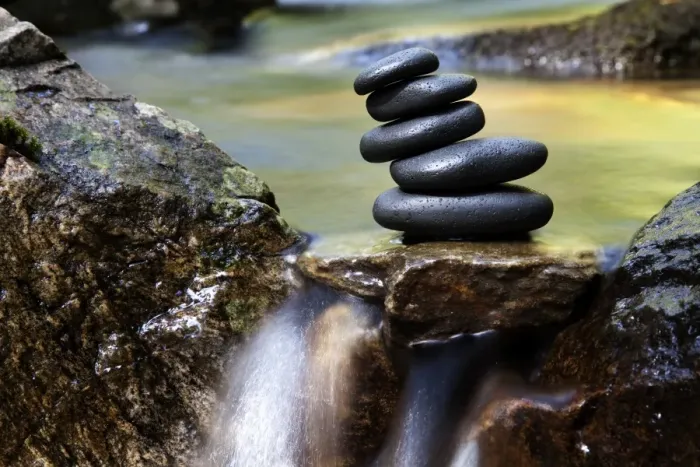 Framed Print : Cairn, stack of basalt rocks in a creek