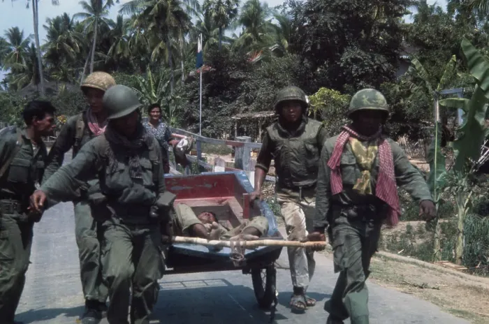 Framed Print : Cambodian soldiers haul wounded comrade Framed Print : Cambodian soldiers haul wounded comrade