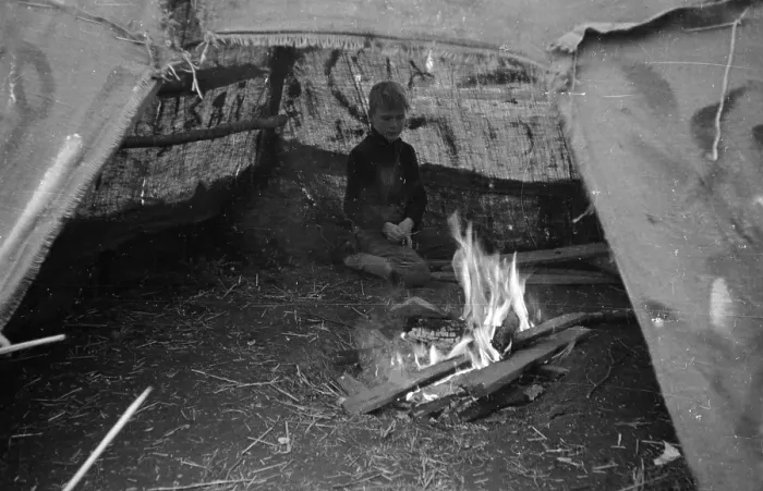 Framed Print : Camp Fire. 16th November 1946: A boy stares into the campfire under the shelter of a tent Framed Print : Camp Fire. 16th November 1946: A boy stares into the campfire under the shelter of a tent
