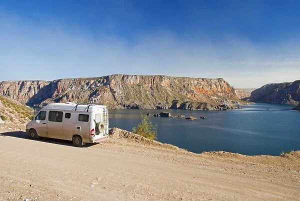 A Camper Van Parked Beside The Lake In Canon Del Atuel