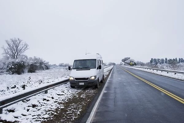 camper van stopped on the side of a snowy road near tucuman