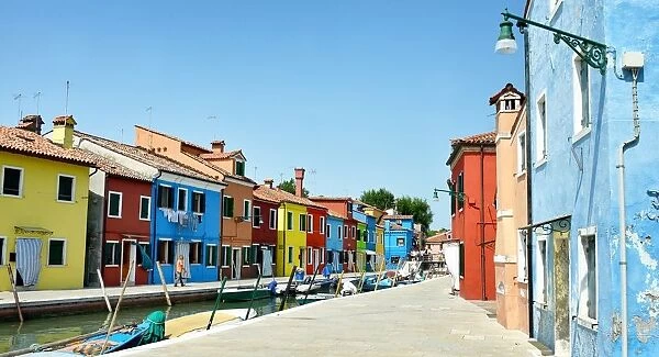 Canals of Burano with boats & colorful buildings