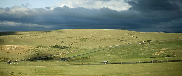 car, cloud, color image, day, field, grass, highway, hill, horizontal, landscape