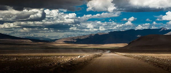 A car running through dirt road in Tibet