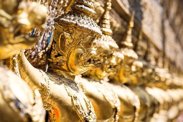 Detail of carved golden statues on temple, Bangkok, Thailand