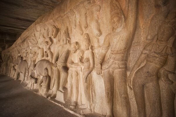 Carving details of Krishna lifting Govar-dhan Hill in order to protect the people of Vrindavan from the fury of Indra at Krishna Mandapa, Mahabalipuram, Kanchipuram District, Tamil Nadu, India