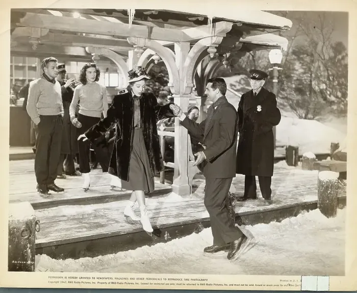 Framed Print : Cary Grant Helping Loretta Young onto Ice Rink Framed Print : Cary Grant Helping Loretta Young onto Ice Rink