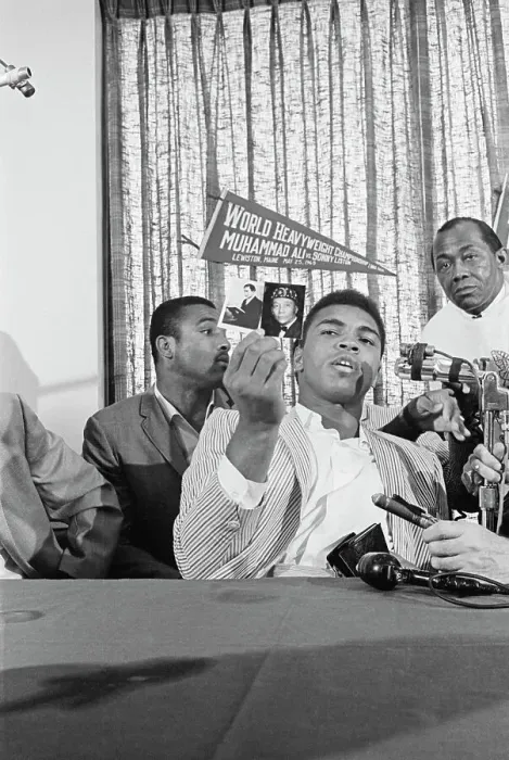 Framed Print : Cassius Clay Holding up Photos of Wallace Fard Muhammad Framed Print : Cassius Clay Holding up Photos of Wallace Fard Muhammad