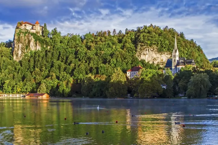 Framed Print : Castle rises on cliffs above Lake Bled, Slovenia