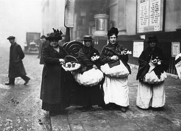 Cat Food. circa 1909: Three women selling cats meat on the streets of Camberwell, London
