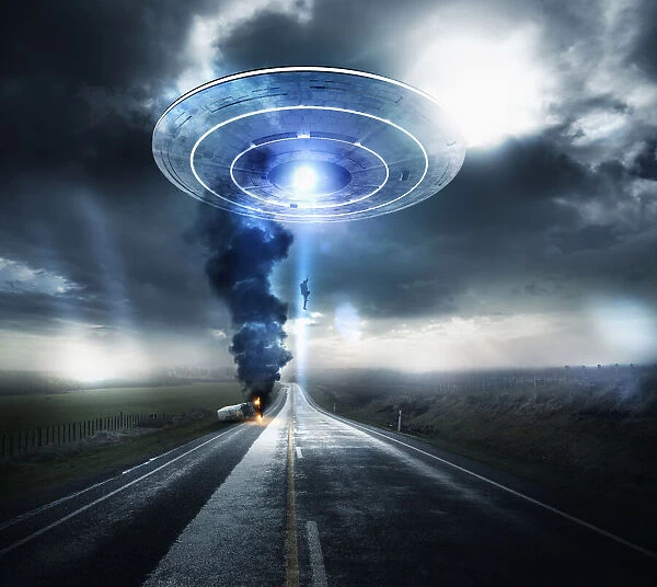 Caucasian man beaming up to UFO over highway
