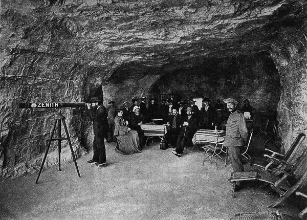 Cave Cafe. circa 1903: A man observes the view through a large Zenith telescope