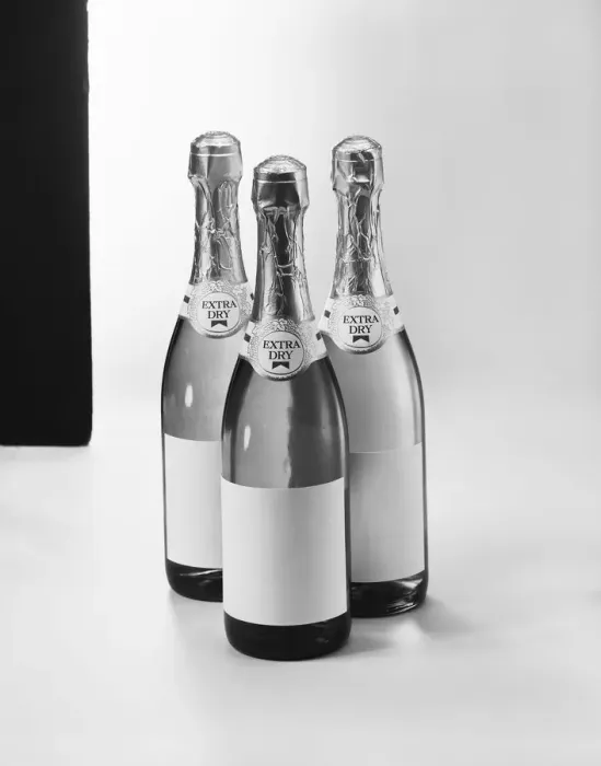 Framed Print : Champagne bottles against white background, close-up Framed Print : Champagne bottles against white background, close-up