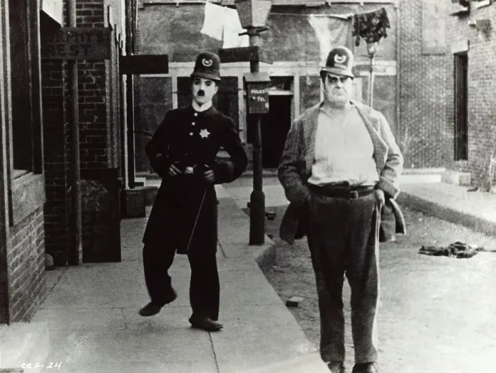 Framed Print : Charlie Chaplin (Left) in Police Uniform Framed Print : Charlie Chaplin (Left) in Police Uniform