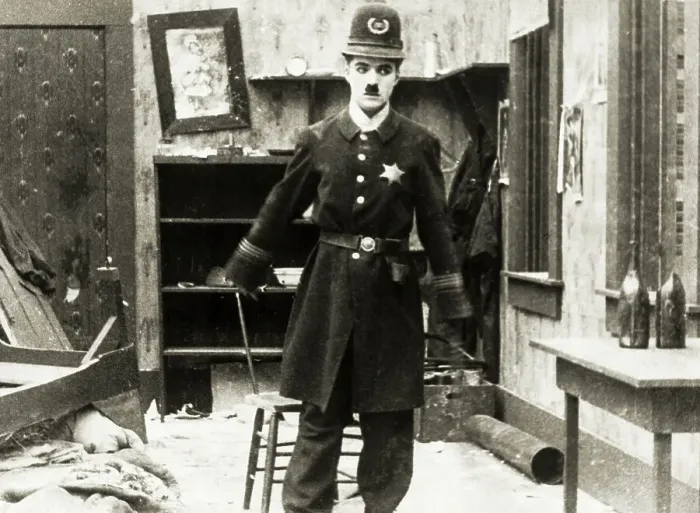 Framed Print : Charlie Chaplin in Police Uniform Framed Print : Charlie Chaplin in Police Uniform