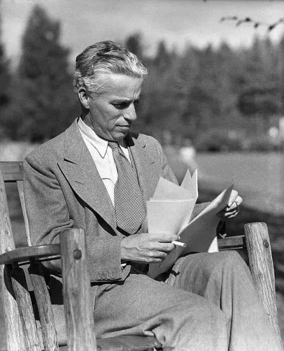 Framed Print : Charlie Chaplin Reads Script Outside Framed Print : Charlie Chaplin Reads Script Outside
