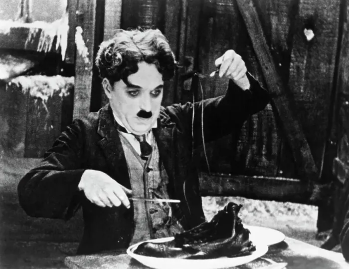Framed Print : Charlie Chaplin in the Shoe-Eating Scene from The Gold Rush Framed Print : Charlie Chaplin in the Shoe-Eating Scene from The Gold Rush