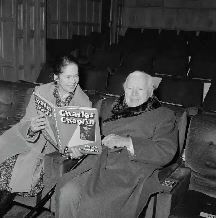 Framed Print : Charlie and Oona Chaplin Looking at a Book Framed Print : Charlie and Oona Chaplin Looking at a Book