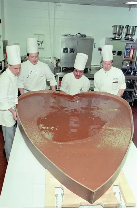 Framed Print : Chefs Pouring Chocolate Into Large Heart Mold Framed Print : Chefs Pouring Chocolate Into Large Heart Mold