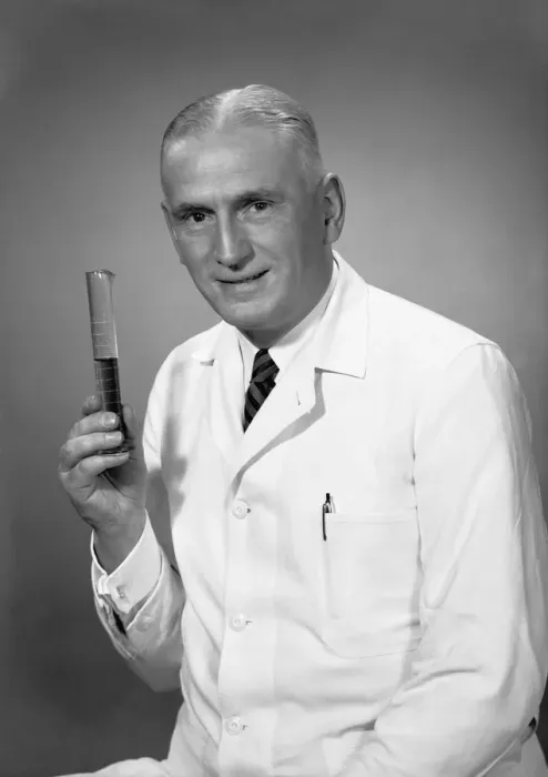 Framed Print : Chemist holding test tube in studio, (B&W), portrait Framed Print : Chemist holding test tube in studio, (B&W), portrait
