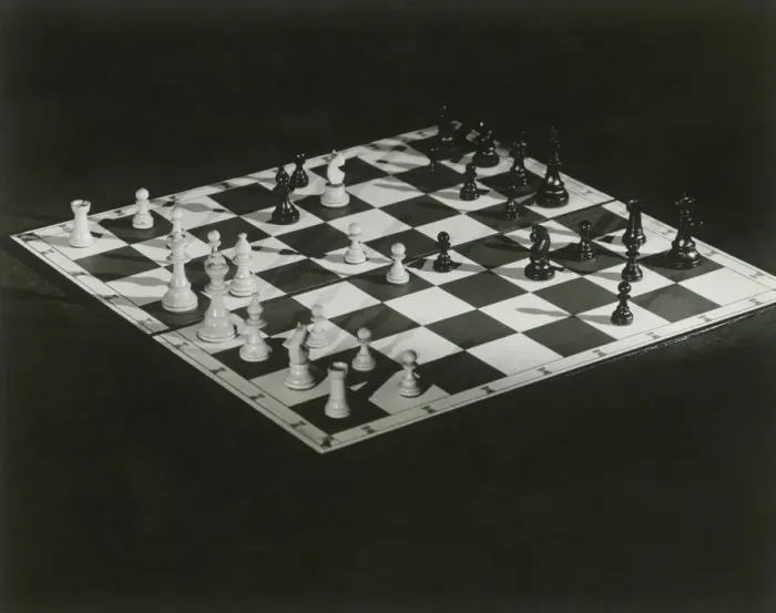 Framed Print : Chess board on black background