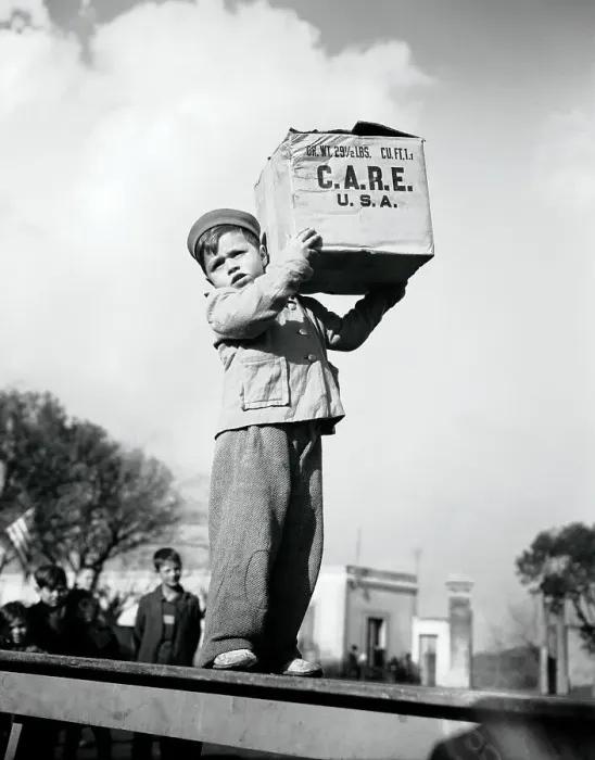 Framed Print : Child Carrying C.A.R.E. Package In Rome Framed Print : Child Carrying C.A.R.E. Package In Rome