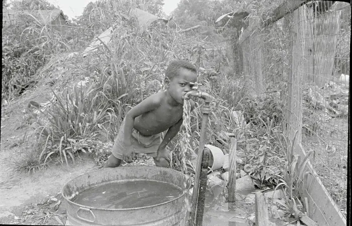 Framed Print : Child Drinking Water from Pipe Framed Print : Child Drinking Water from Pipe