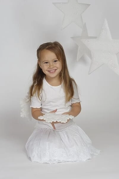 Child, girl wearing an angel costume with stars, Christmas, festive season