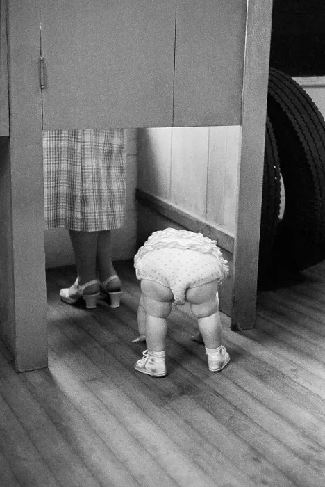 Framed Print : Child Peeking Under Voting Booth Framed Print : Child Peeking Under Voting Booth