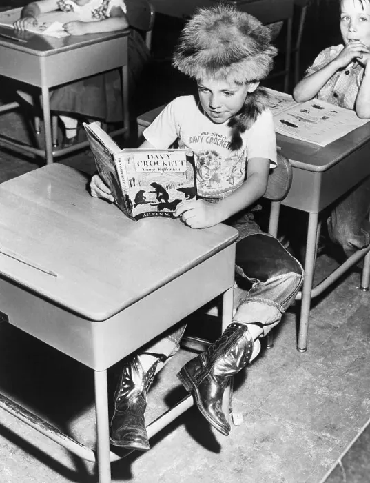 Framed Print : Child Reading about Davy Crockett Framed Print : Child Reading about Davy Crockett