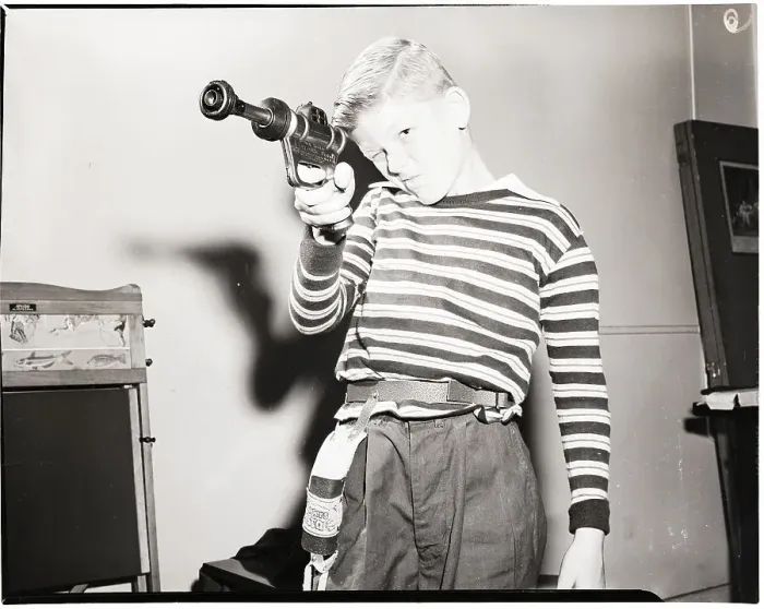 Framed Print : Child Takes Aim with Futuristic Toy Gun Framed Print : Child Takes Aim with Futuristic Toy Gun