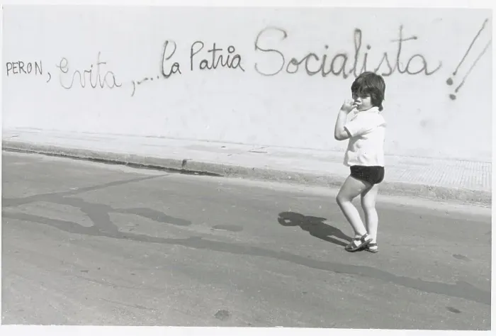 Framed Print : Child Walking by Political Graffiti