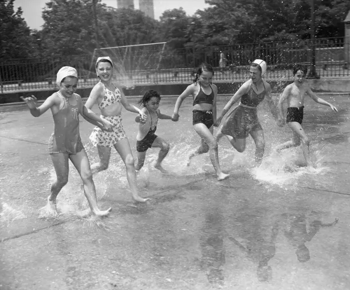 Framed Print : Children (8-9, 10-12) holding hands, running over water