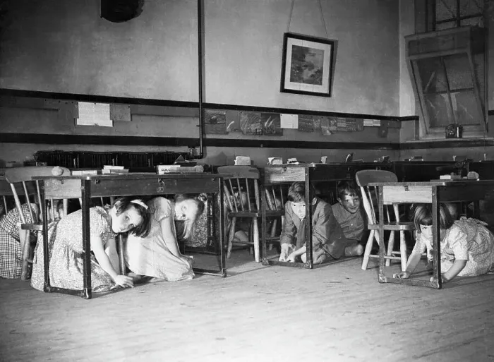 Framed Print : Children Kneel Under Desks During Air Raid Drill Framed Print : Children Kneel Under Desks During Air Raid Drill