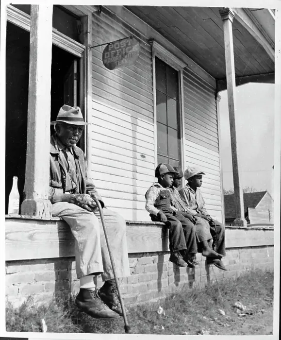 Framed Print : Children and Man Sit in Front of a General Store Framed Print : Children and Man Sit in Front of a General Store