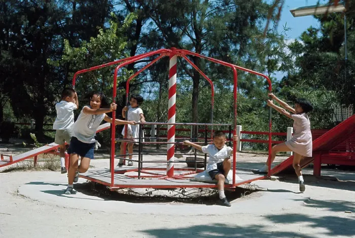 Framed Print : Children Playing on Merry-go-round Framed Print : Children Playing on Merry-go-round