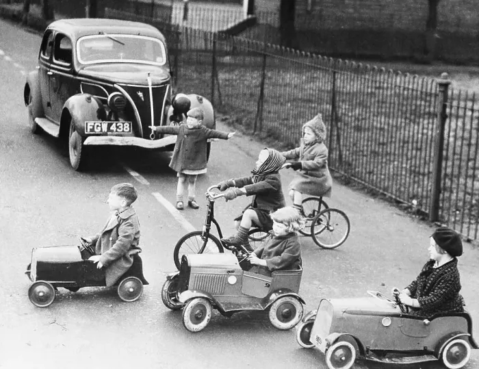 Framed Print : Children playing outside with toy cars and bicycles Framed Print : Children playing outside with toy cars and bicycles